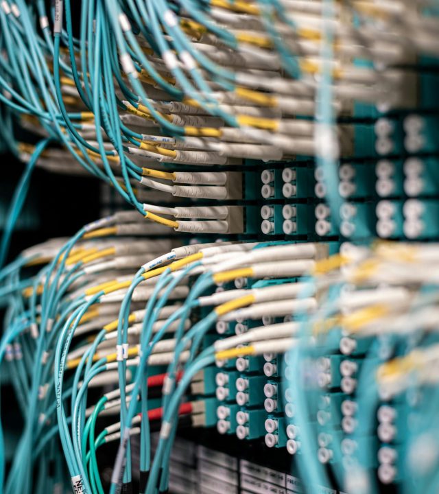 pexels-photo-5087172-5087172 Rows of blue cables and wires plugged into server patch panel located in modern data center framework